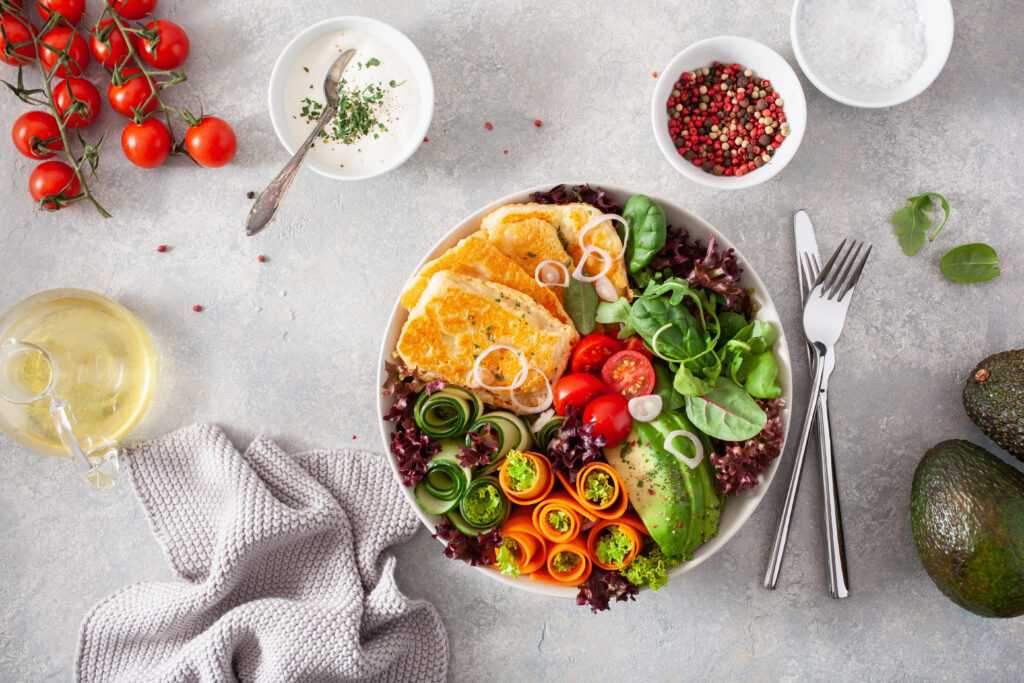 ketogenic paleo diet lunch bowl. halloumi cheese, avocado carrot